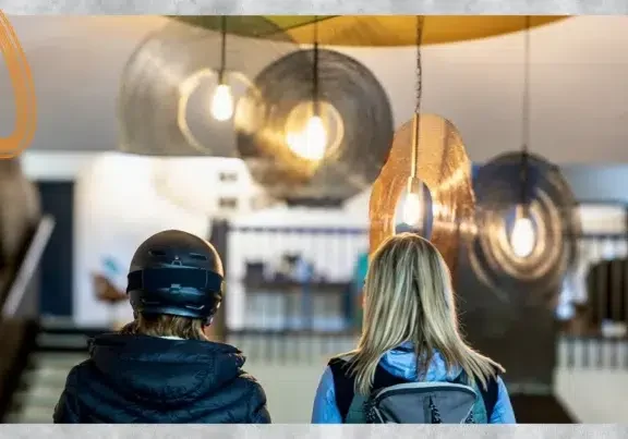 Deux résidentes équipées pour la montagne dans le hall d'une résidence de coliving à Grenoble